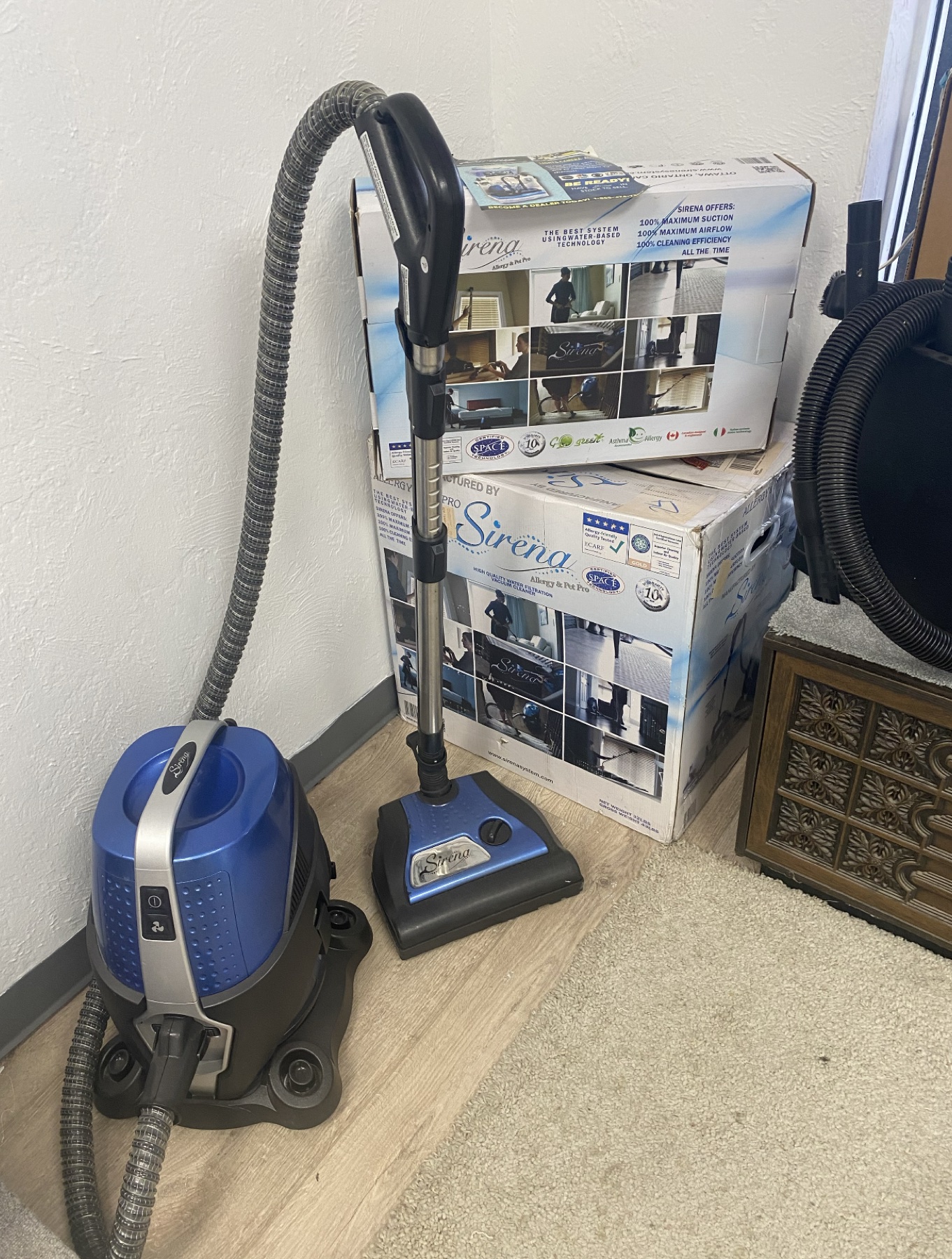 Sirena vacuum system and product boxes displayed in the Skaggs Vacuums showroom